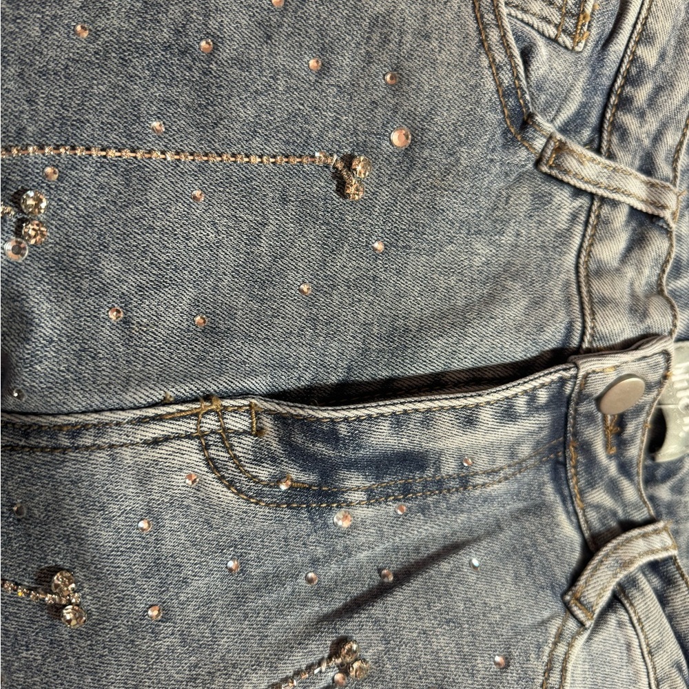 Jeans run a bit small. Rhinestones and fringes are embroidered all over jeans.